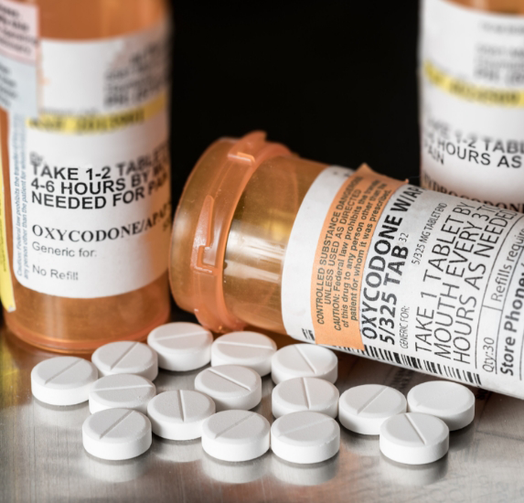 Three orange bottles of prescription opioid pills