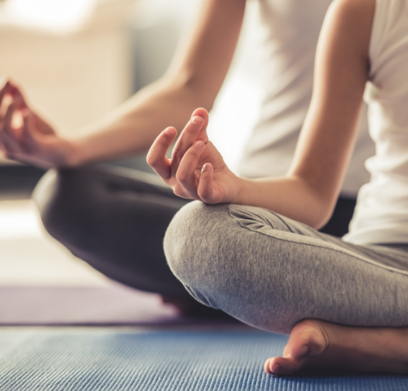 Person sitting on the floor in a yoga pose