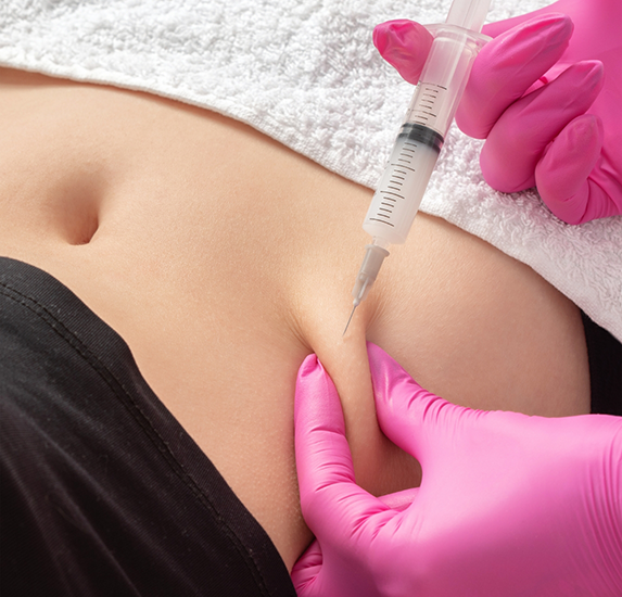 Medical patient receiving an injection in their abdomen